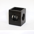 Black modern minimalist Cube-shaped wooden candle holder with circular cutouts showing glass votive holder