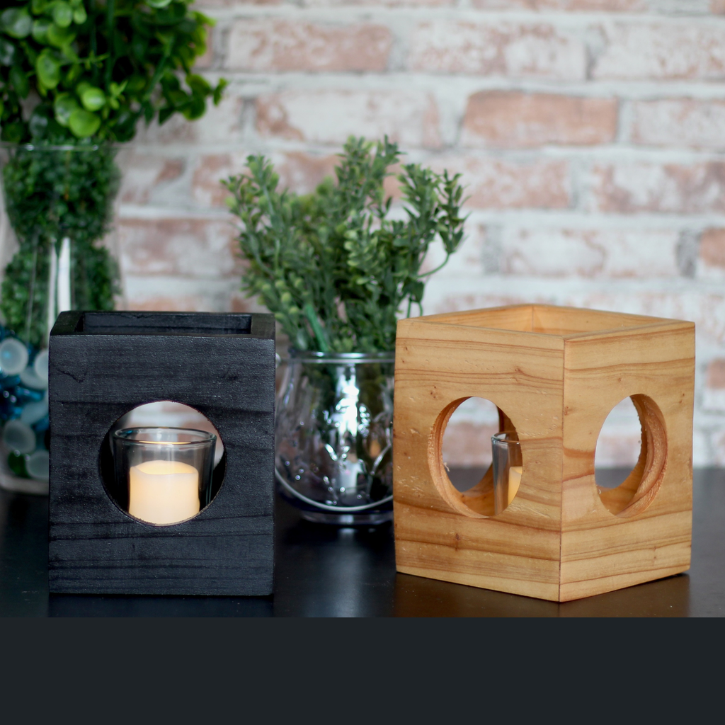 Cube-shaped wooden candle holders with circular cutouts showing glass votive holder