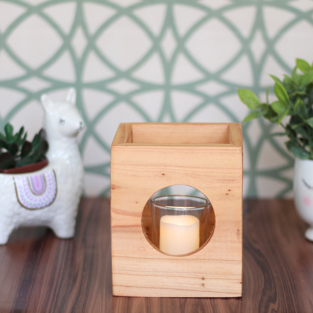 Light wood Cube-shaped wooden candle holder with circular cutouts showing glass votive holder desk decor