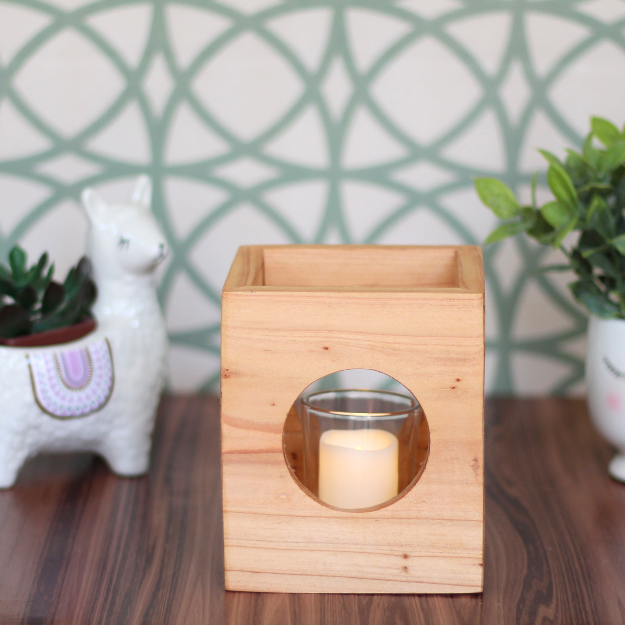 Light wood Cube-shaped wooden candle holder with circular cutouts showing glass votive holder desk decor