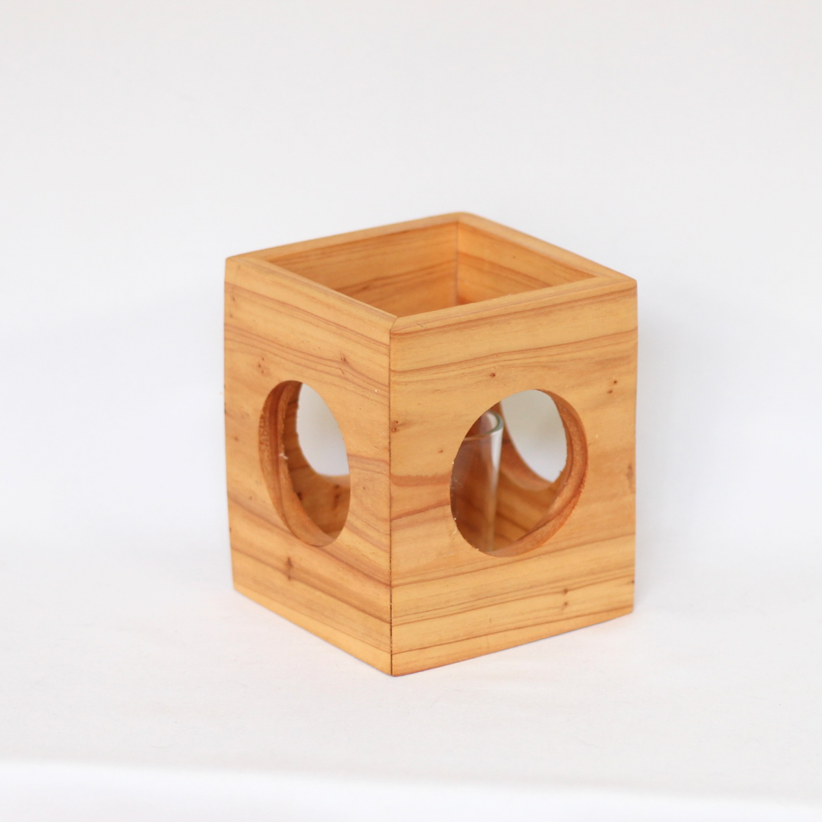 Rustic Cube-shaped wooden candle holder with circular cutouts showing glass votive holder